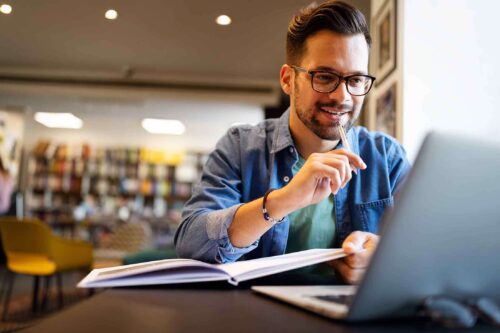 Male studying counselling on laptop