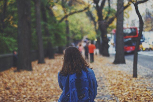 Girl walking to school with backpack