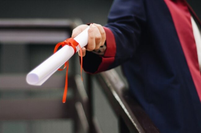 Person Holding a White Scroll