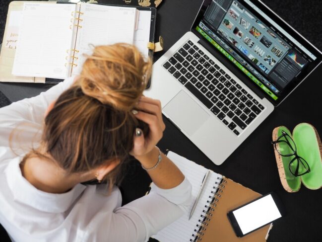 Woman Sitting in Front of Laptop Studying