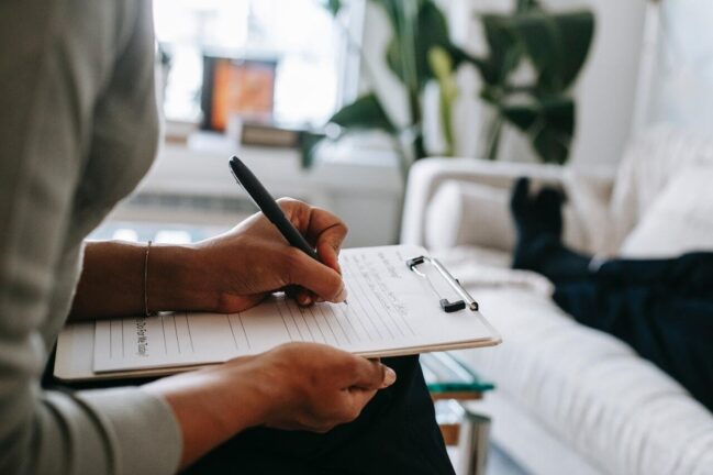 Woman writing down counselling questions